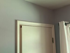 A misaligned door frame and sticking door, a common interior cosmetic indicator of structural movement.