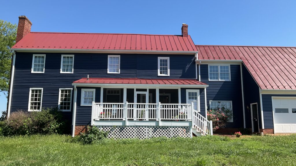 Historic navy blue farmhouse with red metal roof inspected by Dogwood Home Inspection